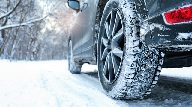 Close up of rear tire on a snowy road